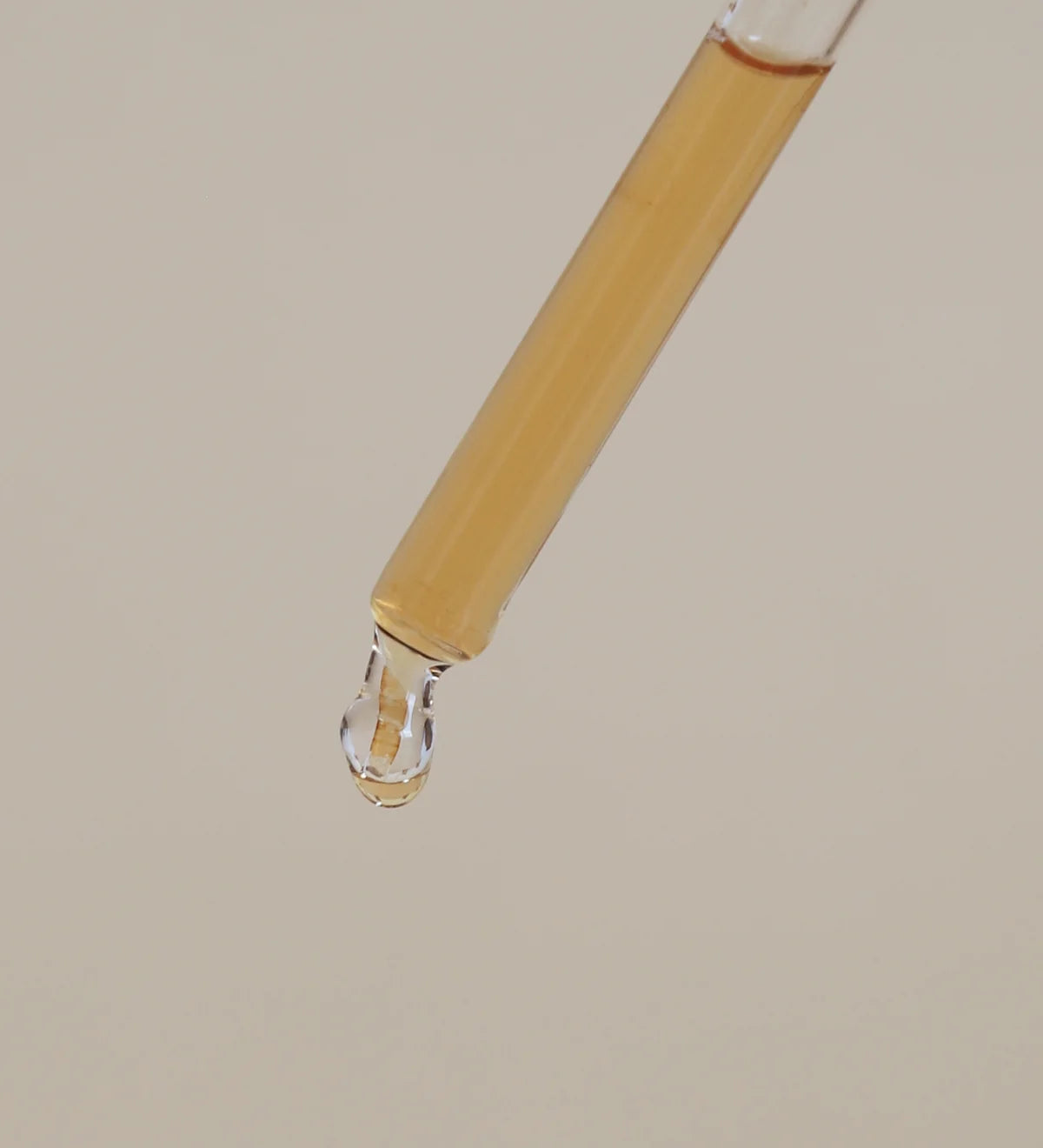 Serum drop of product about to drip.