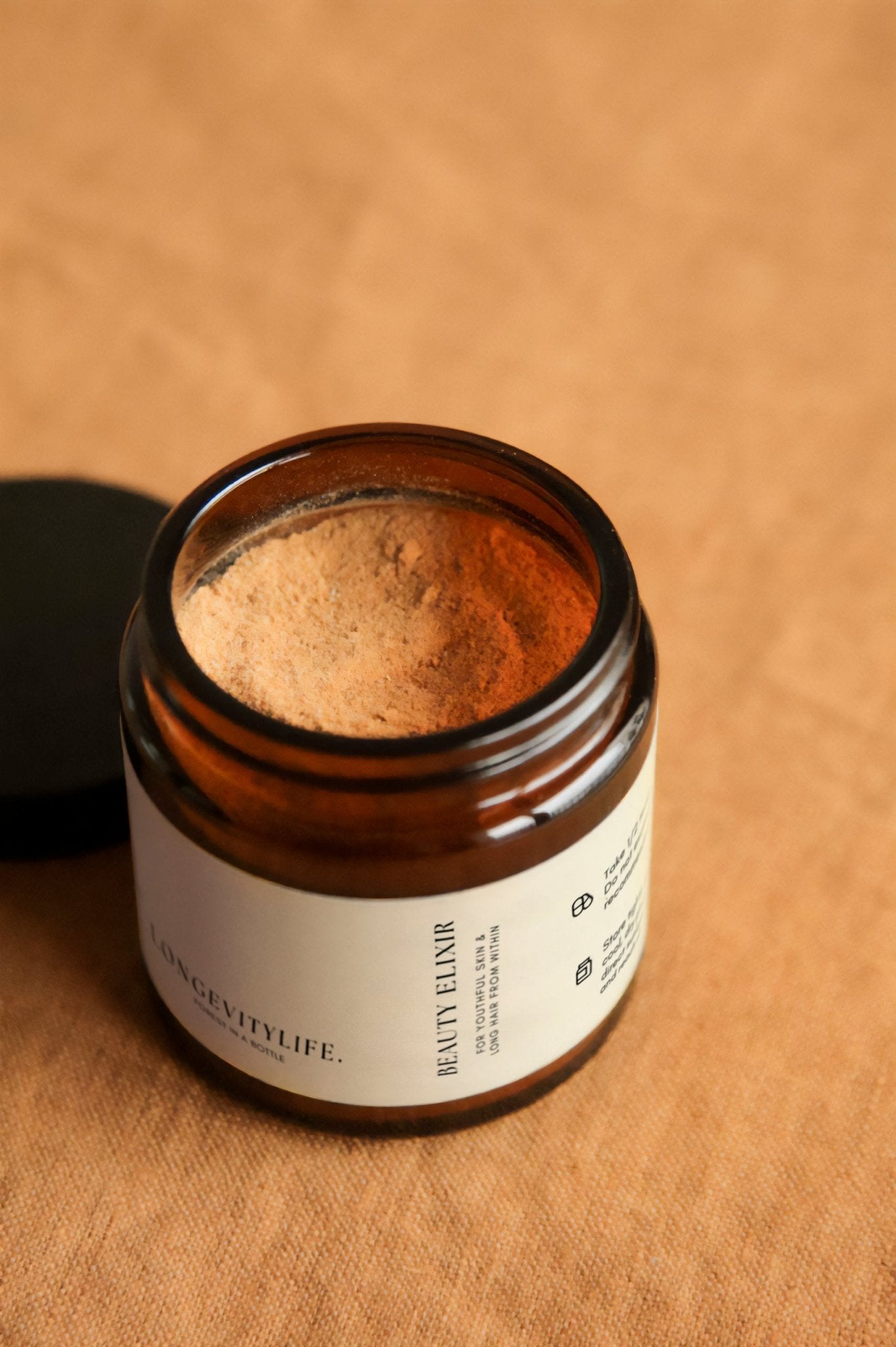 Beauty Elixir powder, made by LongevityLife, on fabric.