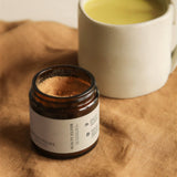 Beauty Elixir powder with golden latte on fabric.