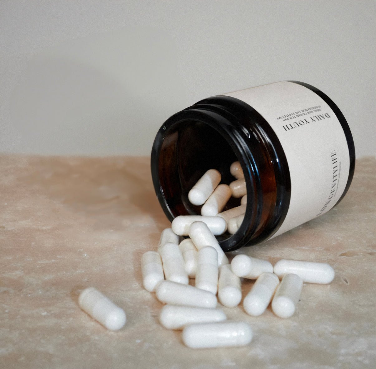 A NMN jar and capsules spilled on the ground.