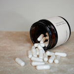 A NMN jar and capsules spilled on the ground.