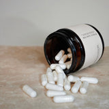 A NMN jar and capsules spilled on the ground.