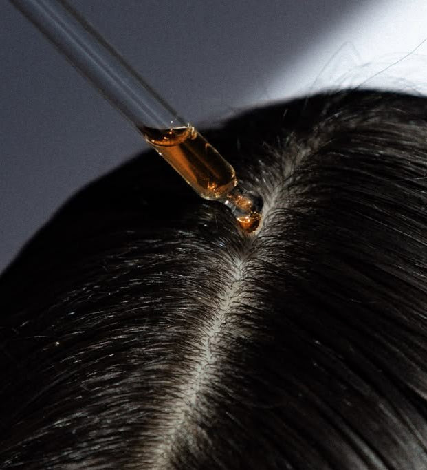 A girl using Hair Serums, made by LongevityLife.