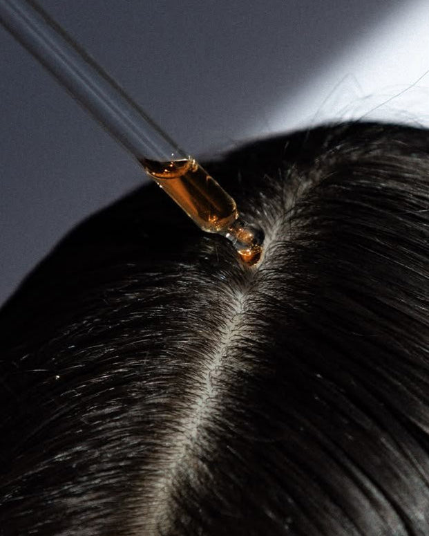 A girl using Hair Serums, made by LongevityLife.