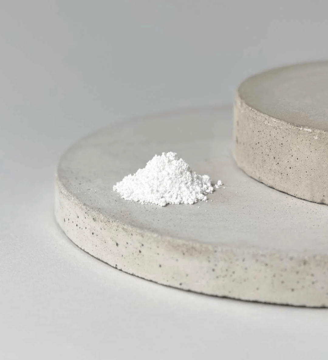 A plate with a mound of NMN powder resting on its surface.