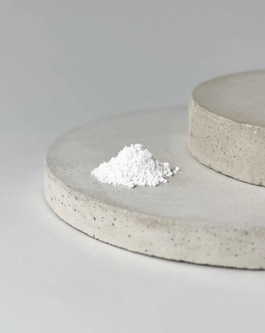 A plate with a mound of NMN powder resting on its surface.