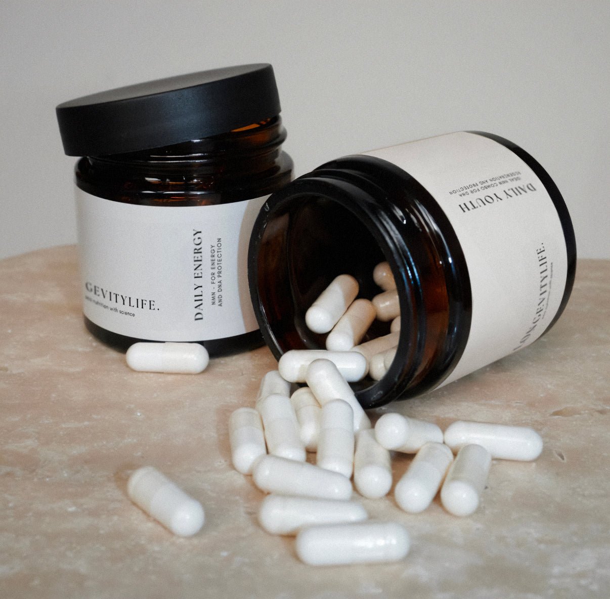 Two jars filled with NMN capsules are placed on a wooden table.