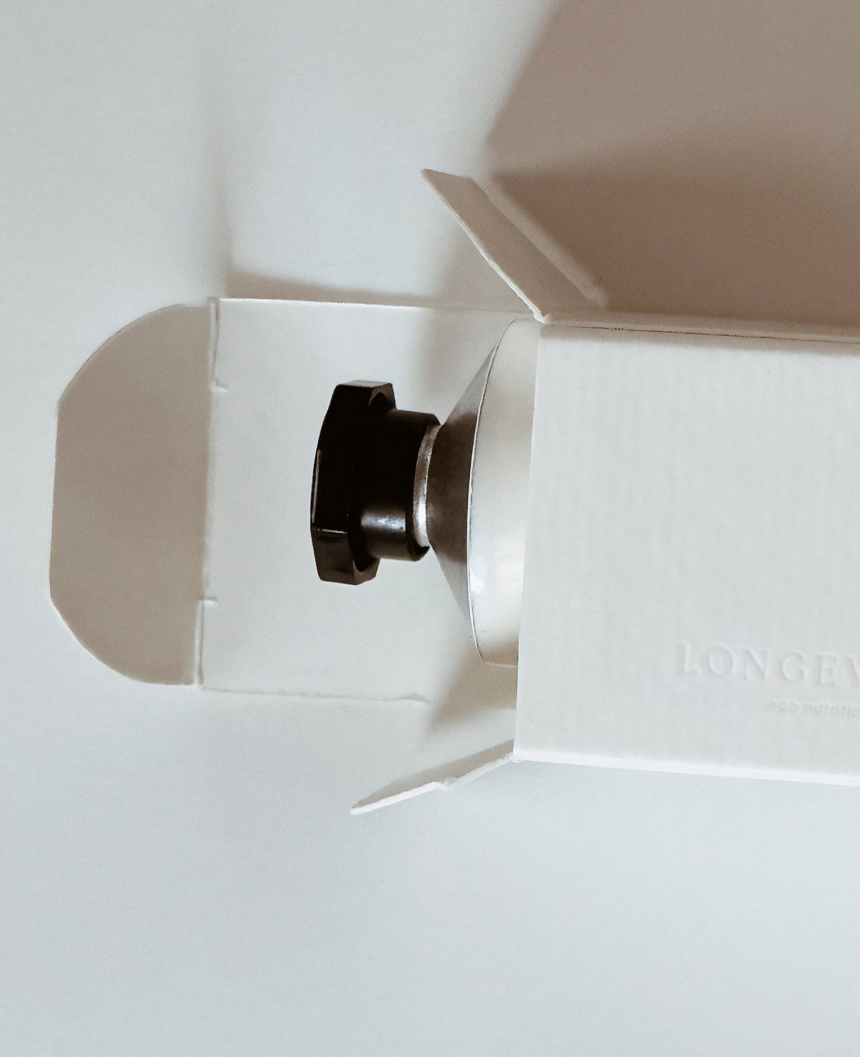 Cose Up of the packaging and top of the Daily Shine bottle.