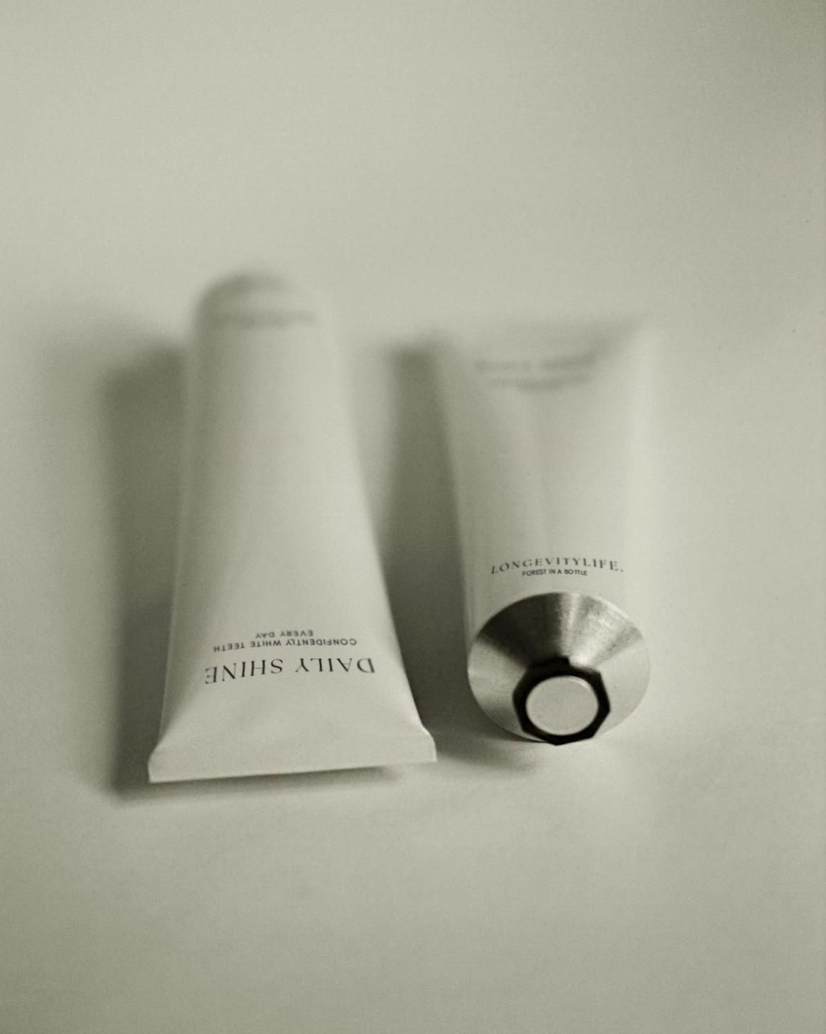 Two tubes of Daily Shine placed side by side on a clean white surface.