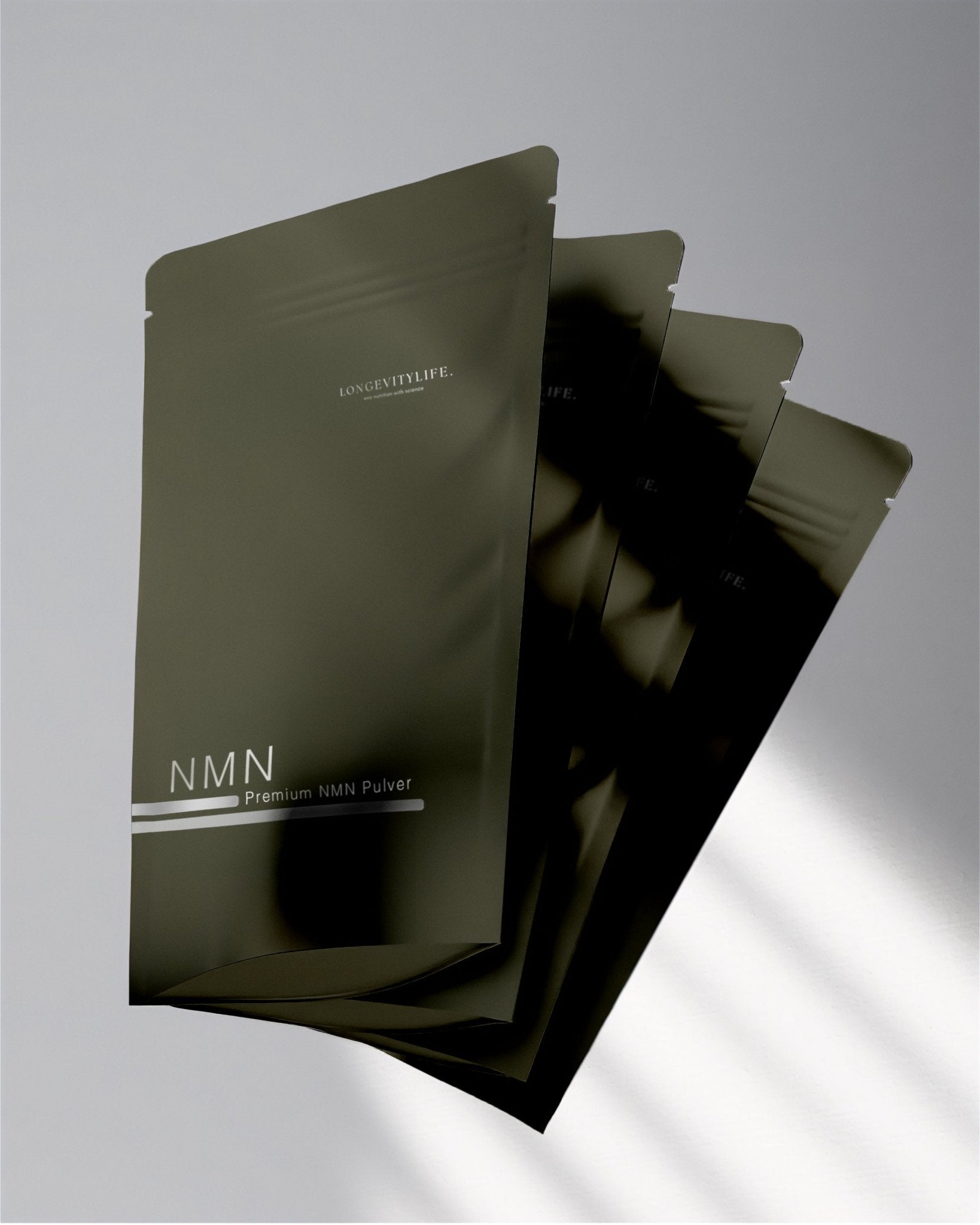 A close up of the NMN green bag, including three of them.