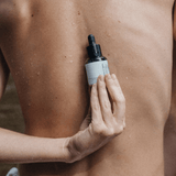 A person holding the perfect skin product on the back.