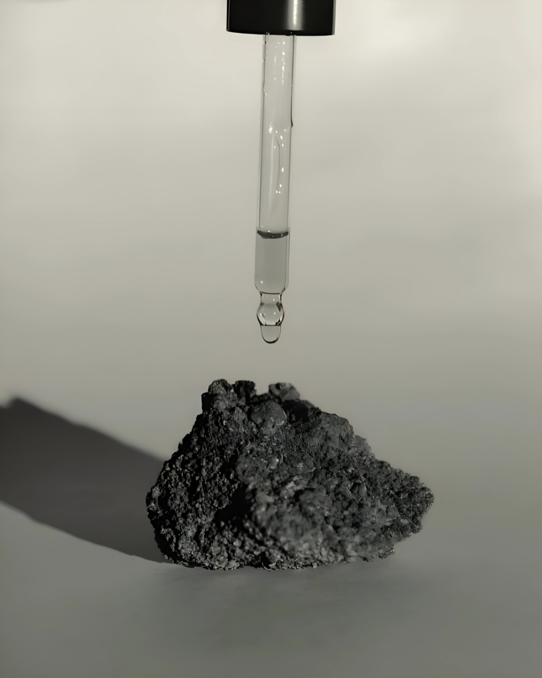 A small black item is positioned atop a rock, highlighting the contrast between the object and the rugged surface.