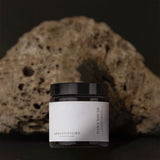 Daily youth NMN jar with rock behind.