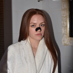 Woman in a white bathrobe wearing a LongevityLife nasal strip