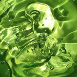 A stream of aloe vera is being poured into a bowl, creating a splash effect.