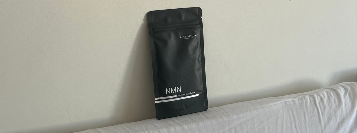 LongevityLife NMN pouch leaned against a wall on a bed
