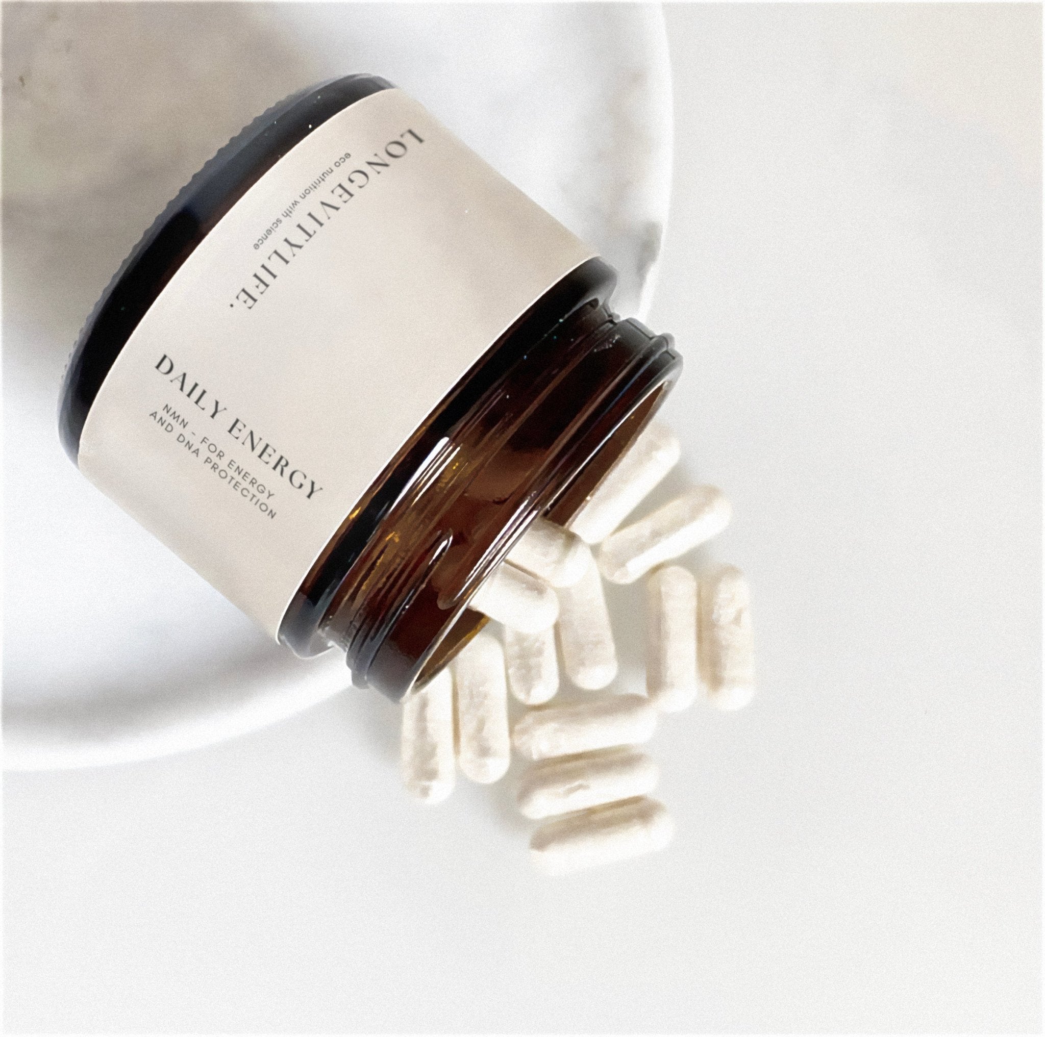 NMN Daily energy capsules spilling from the jar.
