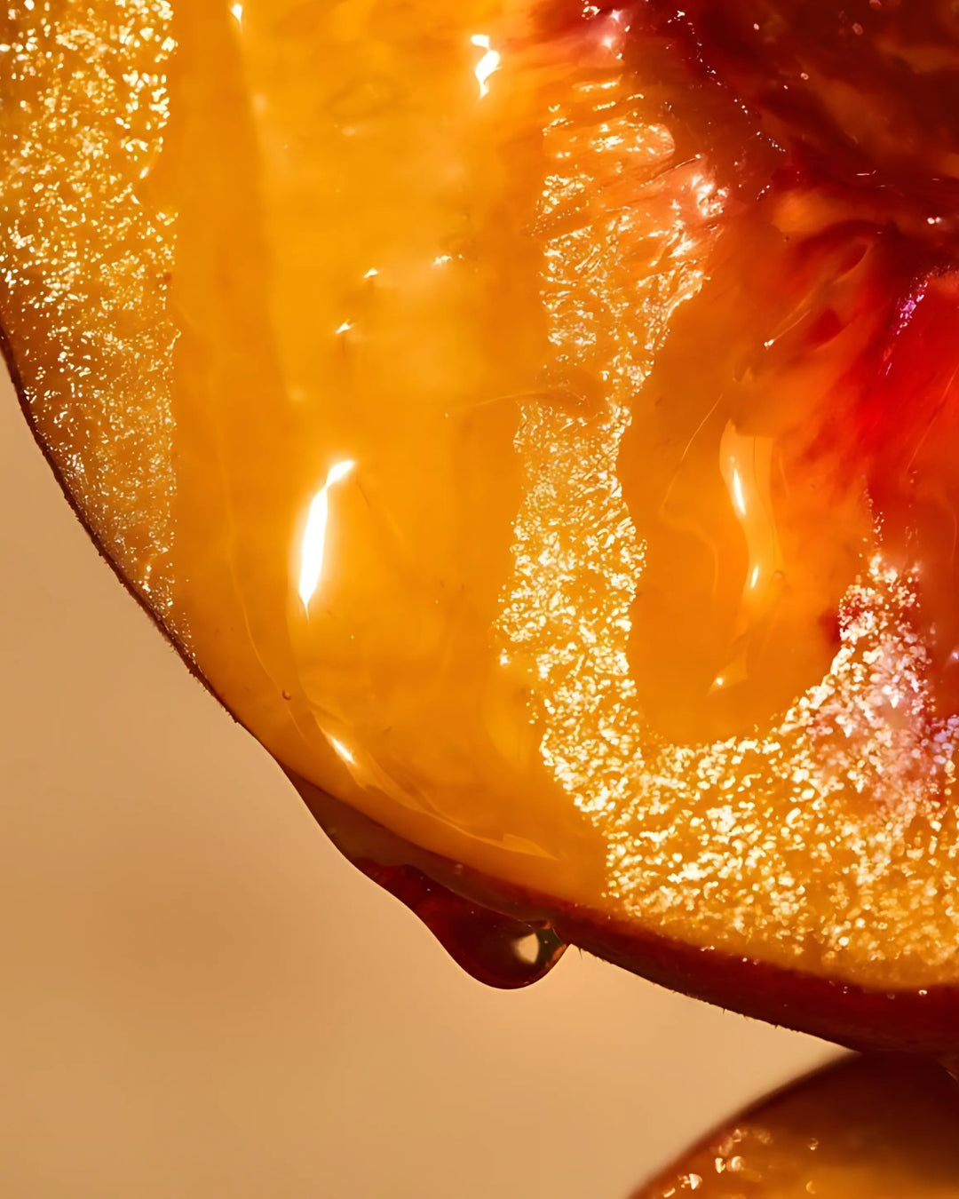 A ripe peach with golden honey dripping down its surface.