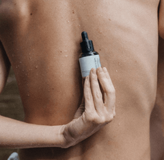 A person holding the perfect skin product on the back.