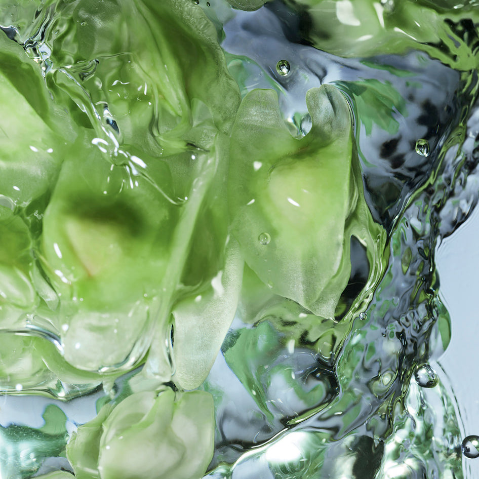 Green gelatinous substance with water droplets