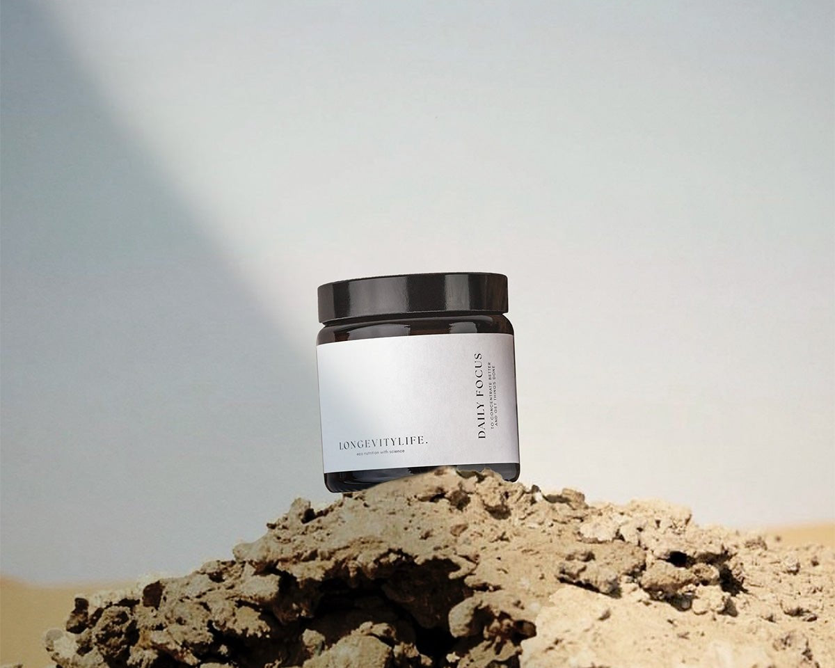 A jar containing capsules to sharpen focus, on top of the rock.